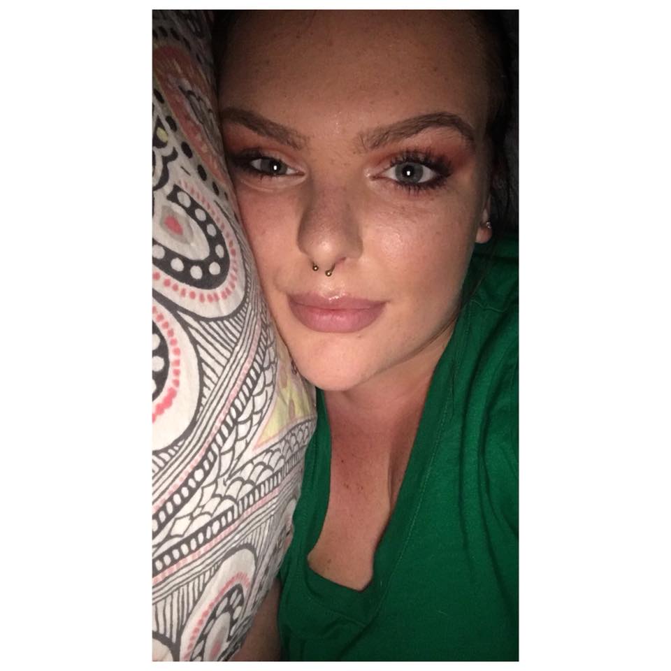 woman wearing makeup and lying in bed