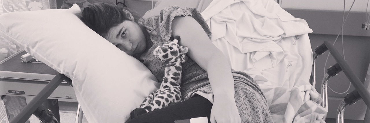 To My Healthcare Team, From an EMT Living With Chronic Illness A photo of the writer laying in her hospital bed.