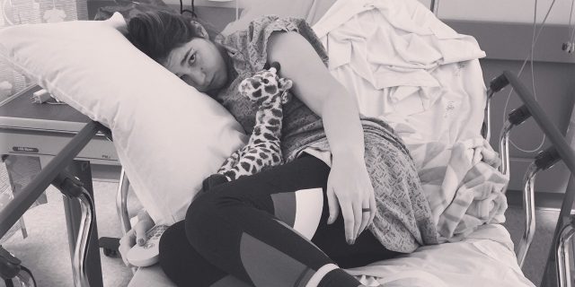 To My Healthcare Team, From an EMT Living With Chronic Illness A photo of the writer laying in her hospital bed.