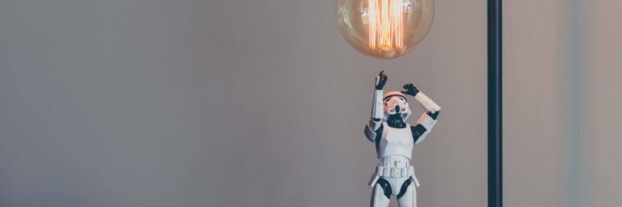 What 'Star Wars: The Last Jedi' Taught Me About My Mental Health storm trooper star wars toy looking up at edison lightbulb
