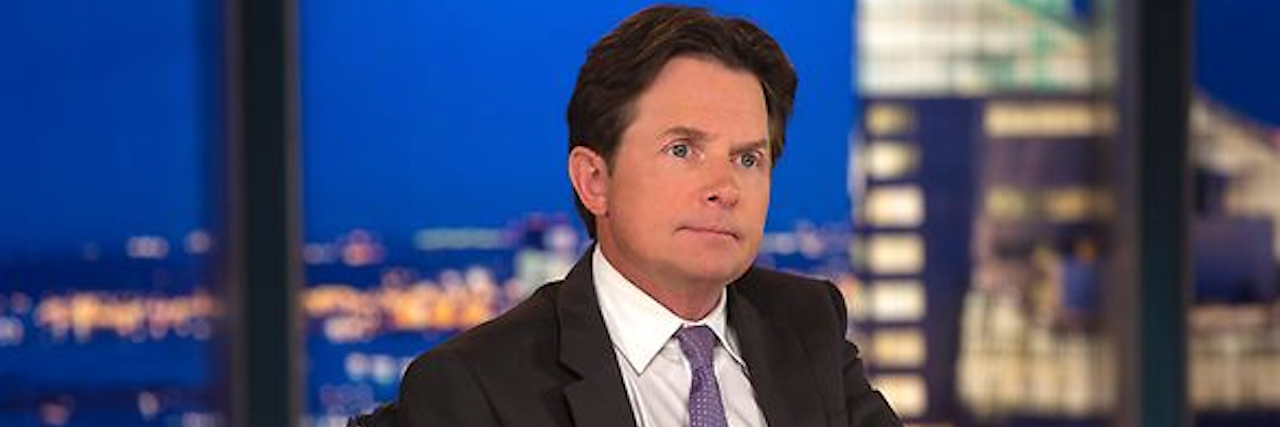 A photo of Michael J. Fox at a TV show desk.