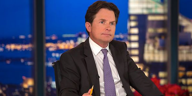 A photo of Michael J. Fox at a TV show desk.