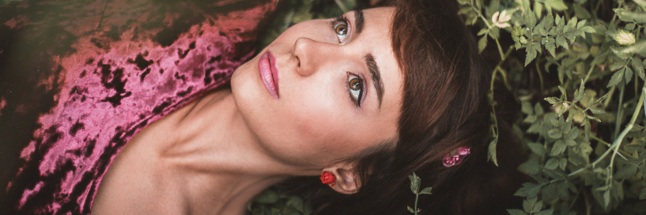 woman lying on back on grass