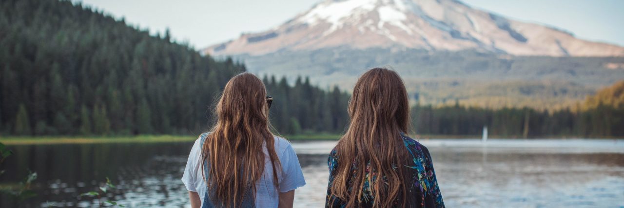 How Bipolar Disorder Has Tested My Friendships friends sitting in front of lake with mountain in distance