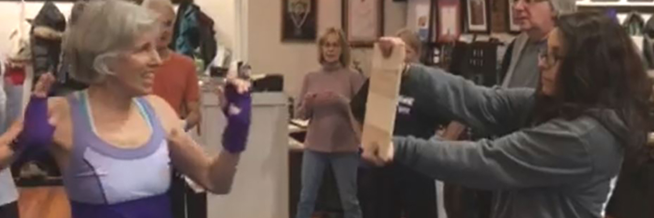 Parkinson's Disease and Fear of Failure Jean getting ready to break wood in Rock Steady boxing class.