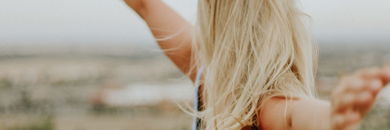 What I Wish for as a Person With Anxiety freedom concept woman with outstretched arms in field