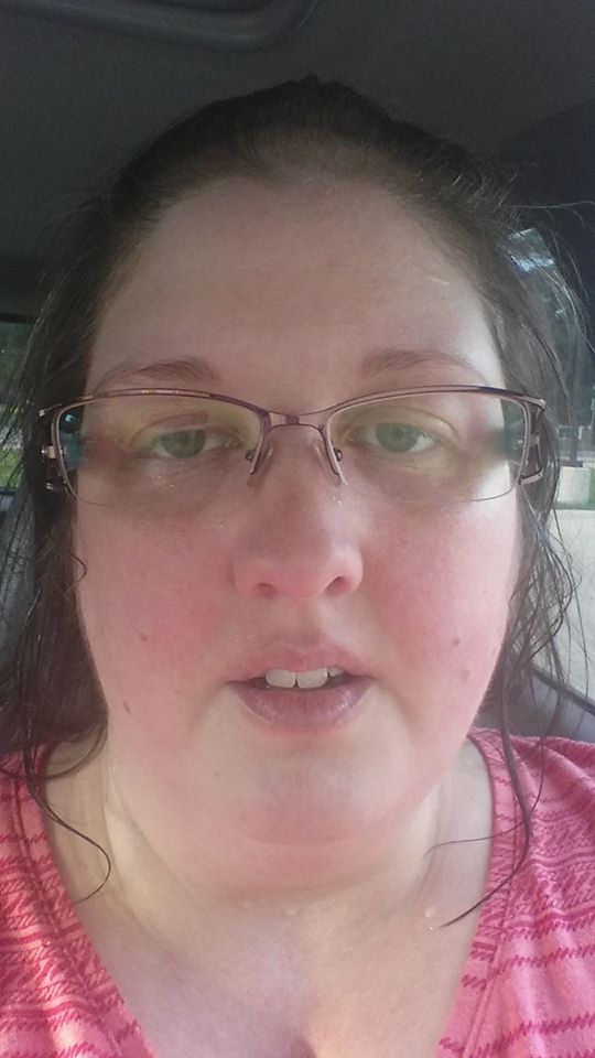 woman sitting in her car sweating after getting groceries