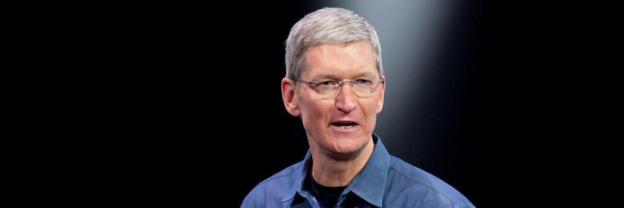 Image of Tim Cook giving a presentation wearing a dark blue shirt
