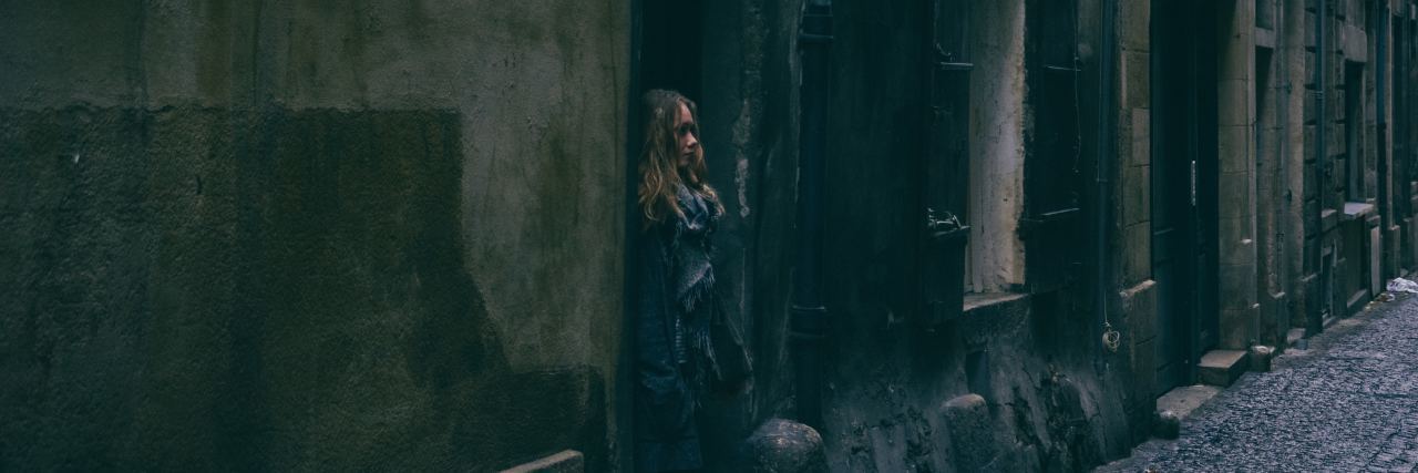 Why I Struggle With the #MeToo Movement as an Abuse Survivor woman standing outside in alleyway in jacket