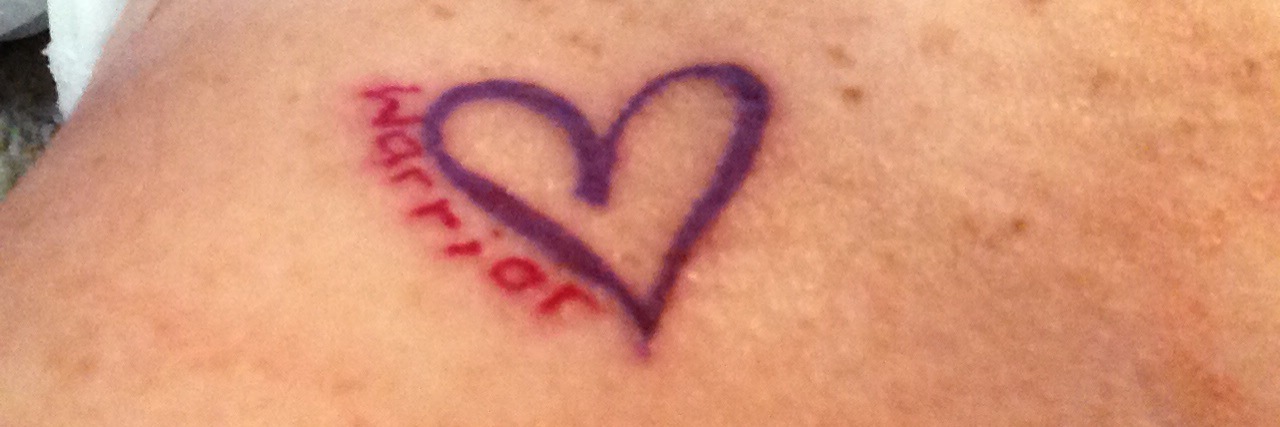 What I Lost and Found With Crohn's Disease woman's stomach with purple heart tattoo that says warrior