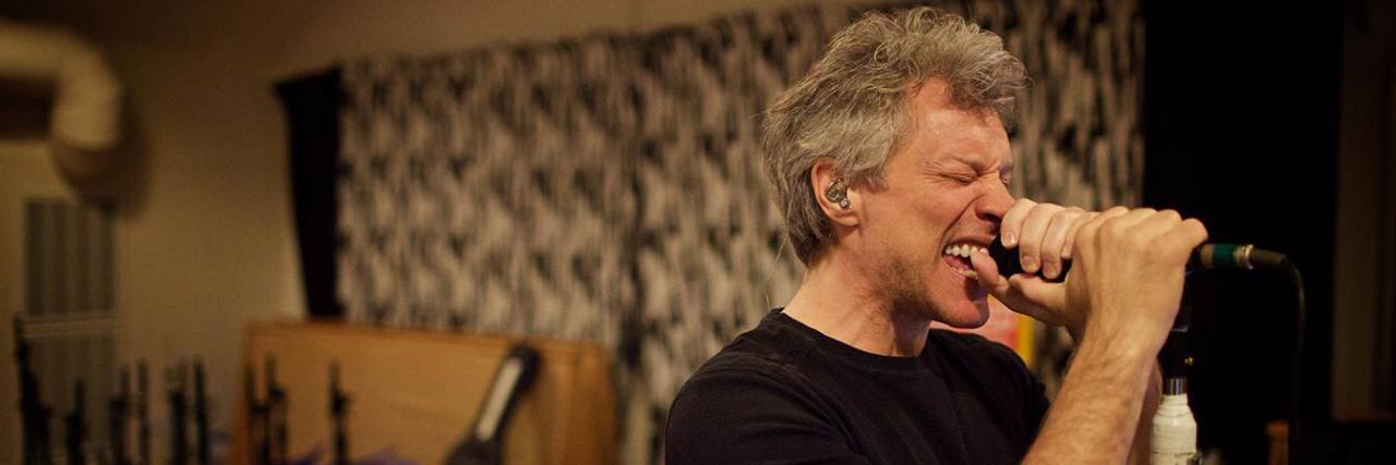 To Bon Jovi, Thank You for Writing My Chronic Illness Soundtrack A photo of Bon Jovi singing into a microphone.