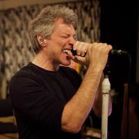 A photo of Bon Jovi singing into a microphone.