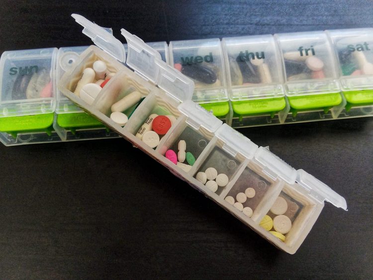 two weekly pill organizers filled with pills