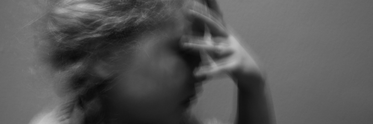 What Life Is Really Like After a Concussion Woman with her head in her hands