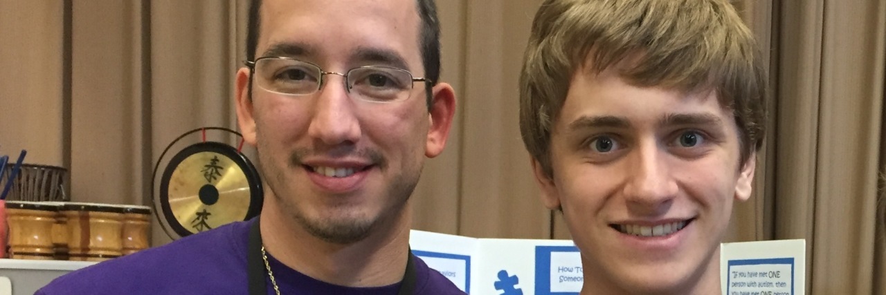 To the Teachers Who Question Where My Son's Autism Begins and Ends Ryan at school holding an ward with teacher by his side