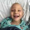 Dax smiling in the hospital without hair