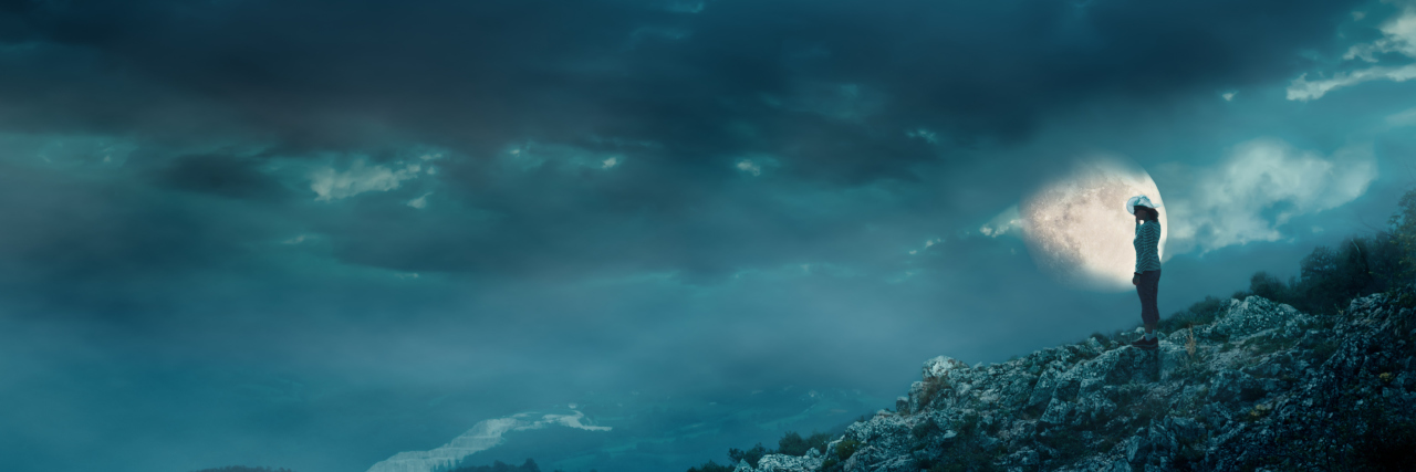 woman on cliff at night with full moon and stormy sky