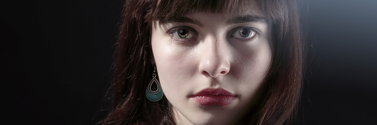 What to Know About Hypermobile Ehlers-Danlos Syndrome (hEDS) portrait of a woman with dark hair and bangs looking at the camera