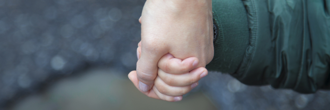 Receiving a Dyskeratosis Congenita Diagnosis For Your Child Mother holding child's hand.