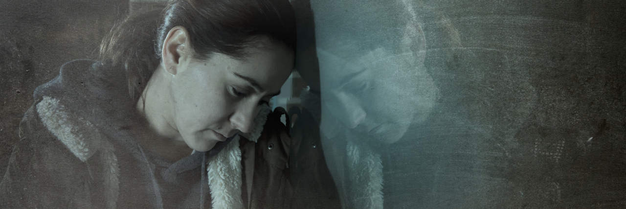 When You're Chronically Ill but Don't 'Look Sick' woman leaning against a window in the street at night