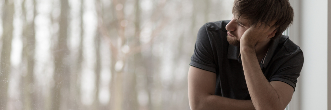 How I Knew My Husband Was Recovering From Depression Young miserable depressed man sitting and thinking