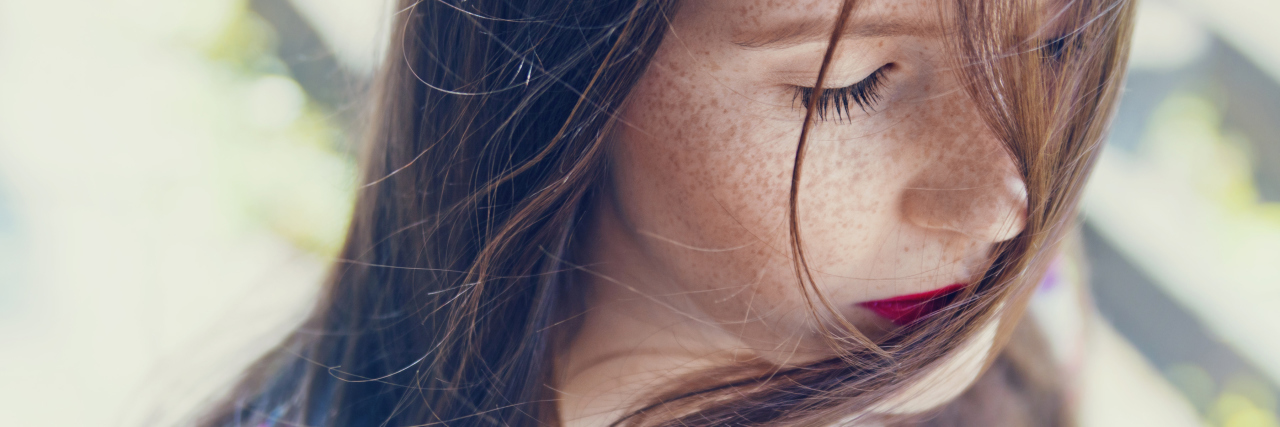 What I Wish People Knew About My Life With Agoraphobia A woman with the wind blowing through her hair