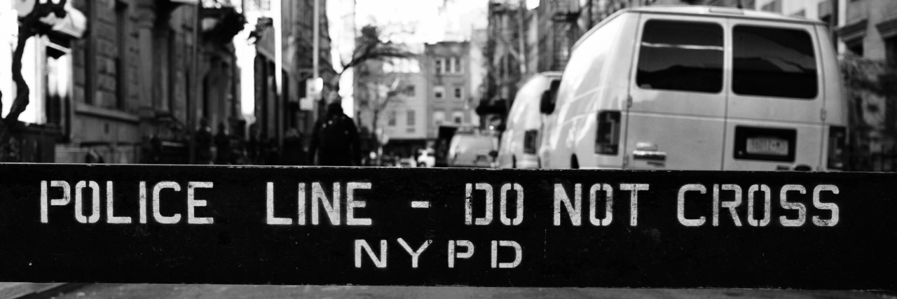 black and white photo of police line NYPD across street