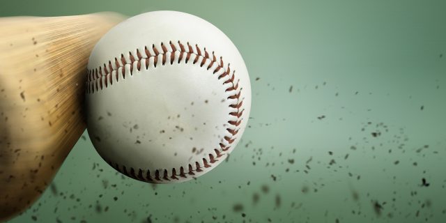 A baseball bat hitting a baseball.