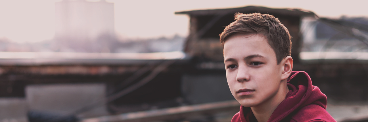 Growing Up With Kallmann Syndrome and Experiencing Loneliness Lonely teenager sitting on roof the house