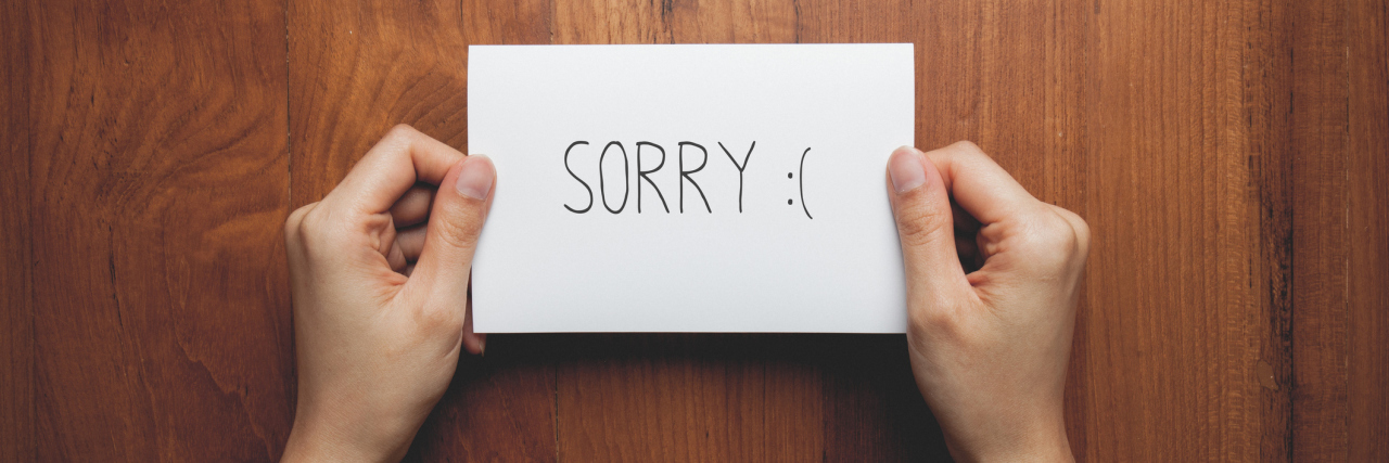 Why I Owe My Friends an Apology After My First Year of Chronic Pain Two hands holding a note that say "Sorry."