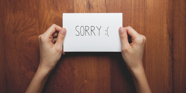 Why I Owe My Friends an Apology After My First Year of Chronic Pain Two hands holding a note that say "Sorry."