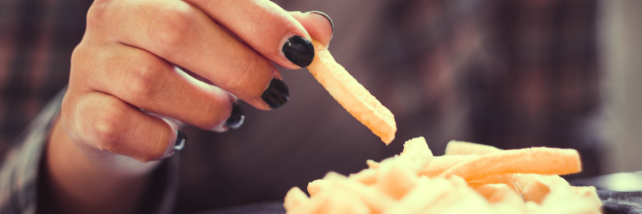 A Letter Weight Watchers, From a Woman in Eating Disorder Recovery A woman eating french fries