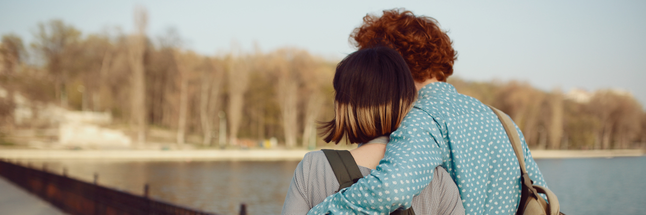 It's Not Easy to Tell Your Partner About Your Rare Disease Couple in love walking by the lake and talking