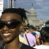 Profile of smiling, young woman in front of Capitol Hill