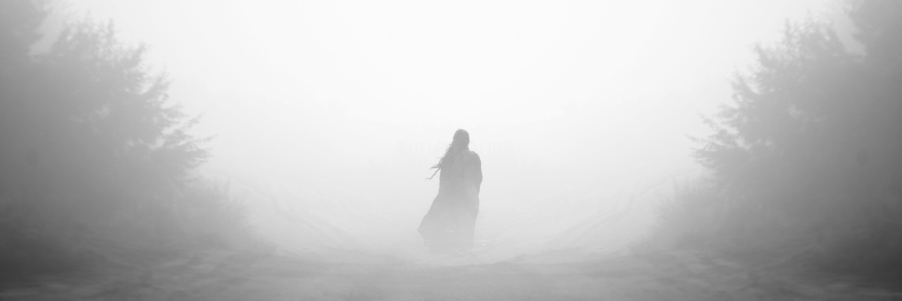Mysterious woman in fog.