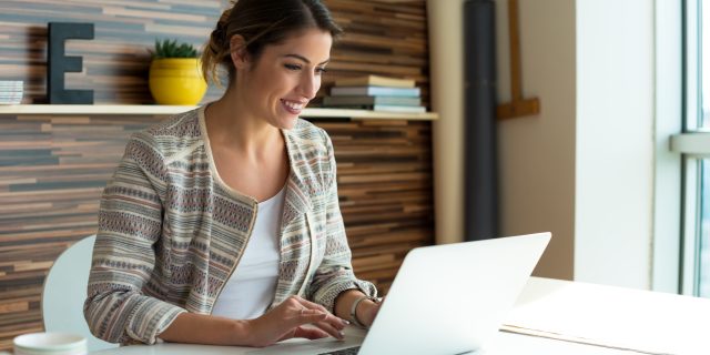 How Joining a Rare Disease Support Group Helped Lighten My Load Young Women working on a Computer