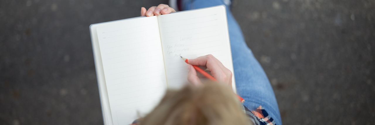 To the People Who Stand by Me and My Illness A girl writing in a notebook.