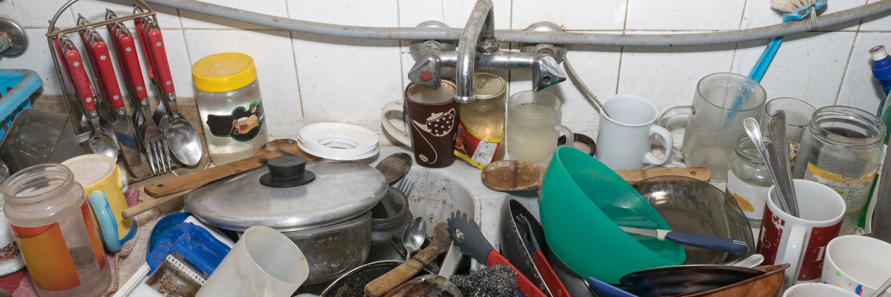 When Depression Makes You Seem Like a 'Messy' Person Pile of dirty utensils in a kitchen washbasin