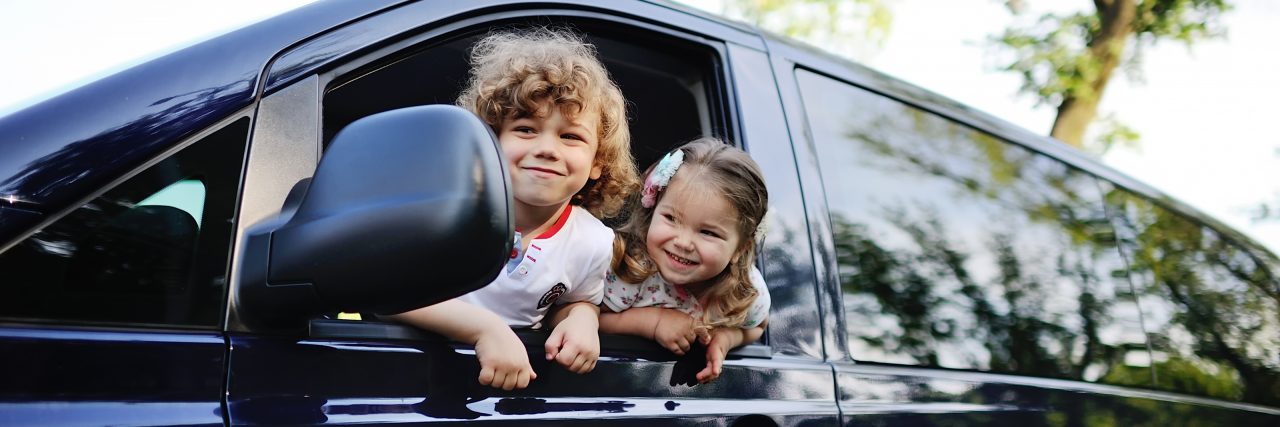Receiving a Donated Wheelchair Accessible Van Children look out from a car window.
