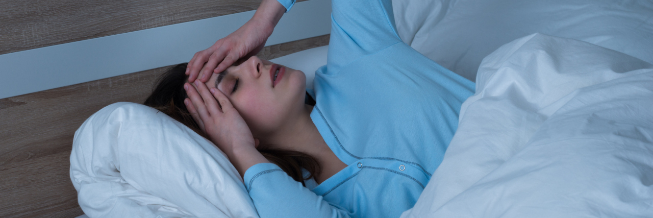 Struggling With Insomnia Due to Fibromyalgia woman tossing and turning in bed at night