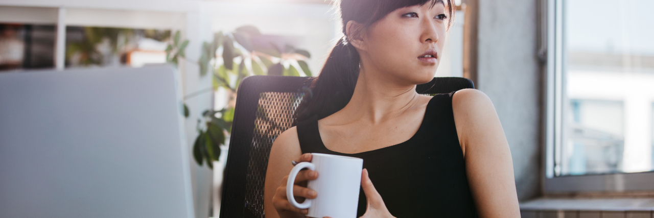 How Making a Video Game Helped Me With My Depression business woman sitting at desk taking coffee break