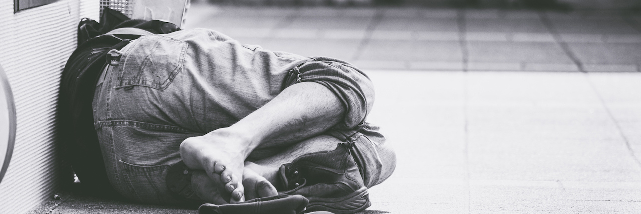 Shot and Killed, Homeless Man Struggled With Schizophrenia Homeless man sleep on the street, in the shadow of the building.