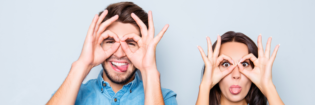 Autism and Finding a True Best Friend happy couple making glasses with fingers and showing tongue