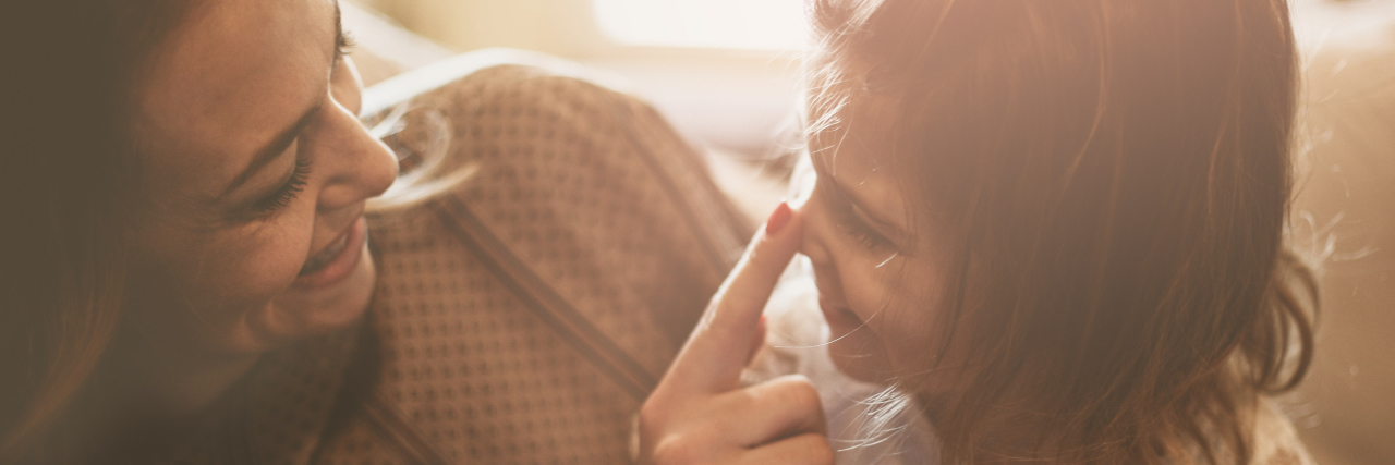 Tips for Parenting With Chronic Fatigue Syndrome mother and daughter laughing and playing together