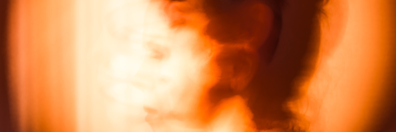 Lessons I've Learned From Chronic Migraine About Mindful Living A woman with a migraine creatively shown.