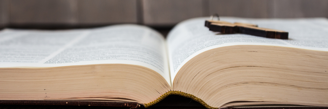 What to Give Up for Lent If You Have Chronic Illness wooden cross lying on an open bible