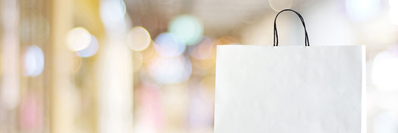 The 3 Gifts My Father Gave Me After My Thyroidectomy White shopping bag on wooden table over blurred store background, business, template, product display montage background