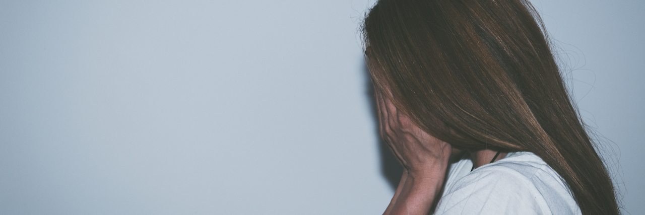 When Mental Illness Makes It Hard to Handle the Unexpected A woman covering her face with her hands