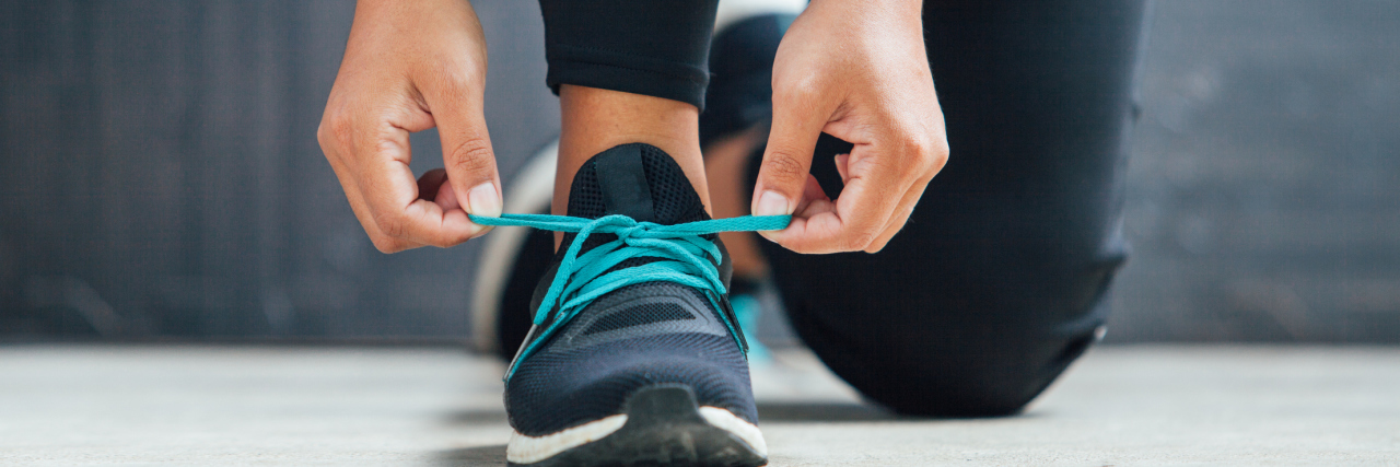 Eating Disorder Recovery: When Can I Exercise Again? Female runner tying her shoes preparing for a run