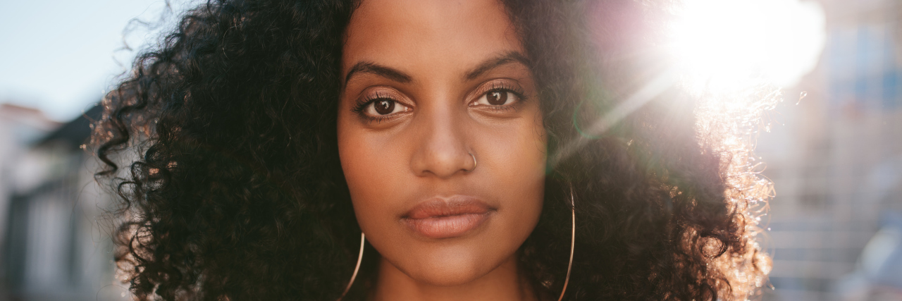 How to Manage Self-Care With Pompe Disease Close up portrait of beautiful young african woman with curly hair.